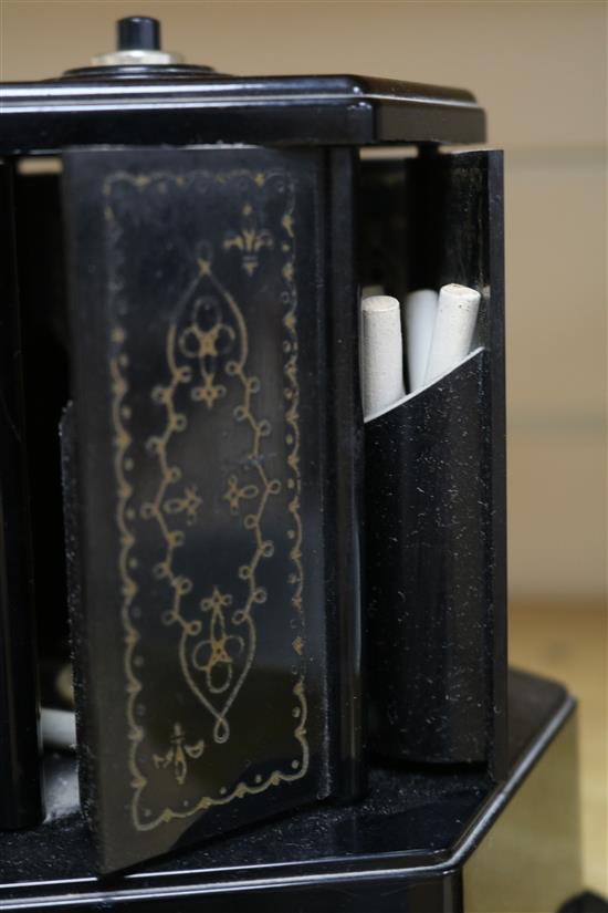 A bakelite musical cigarette dispenser and a similar Crown Derby pottery kennel, 21cm.